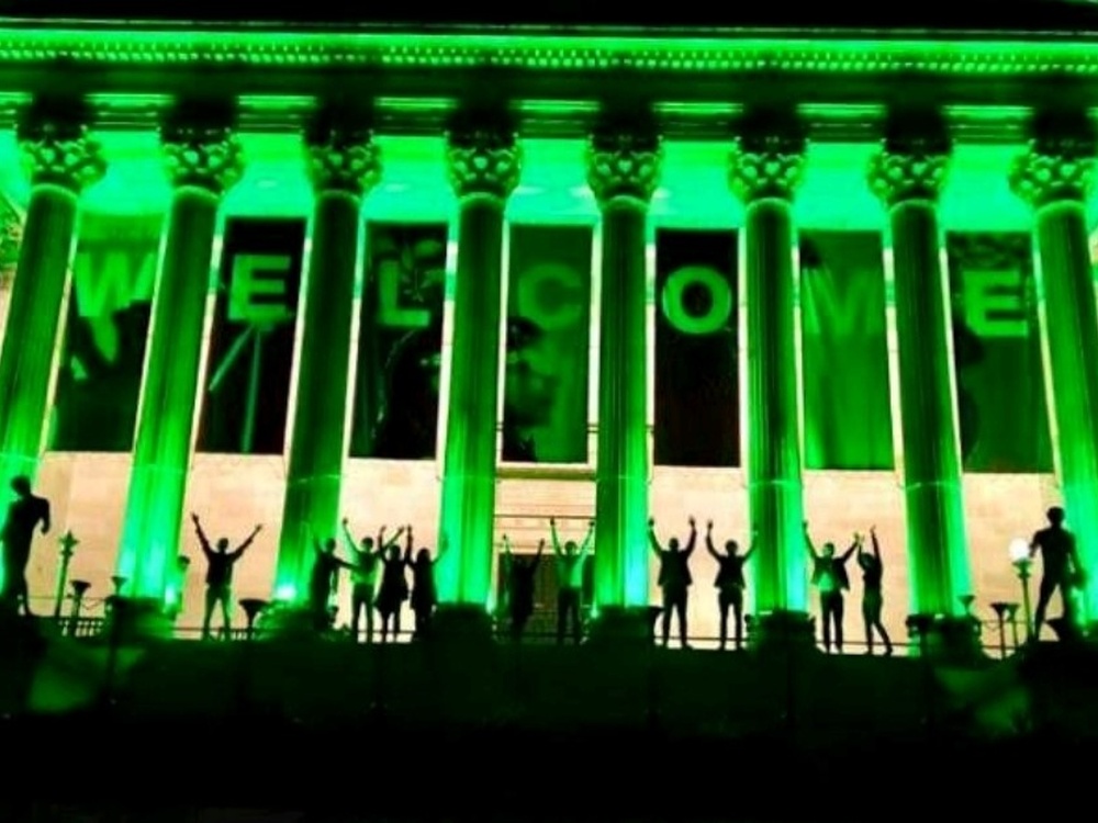 UCL Portico in London lit up green in the darkness