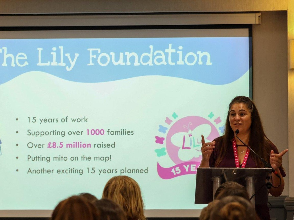 Liz, the Lily CEO and Founder, stands in front of a large screen making a presentation