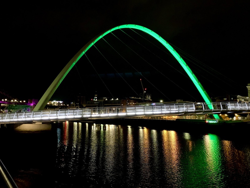 Gateshead Millennium Bridge in the darkness lit up green