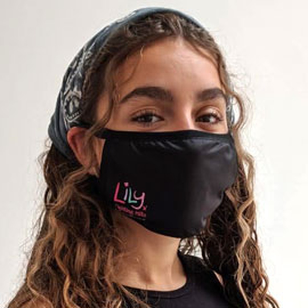 A woman wearing a black face mask featuring the Lily Foundation logo in the bottom corner and the words fighting mito.