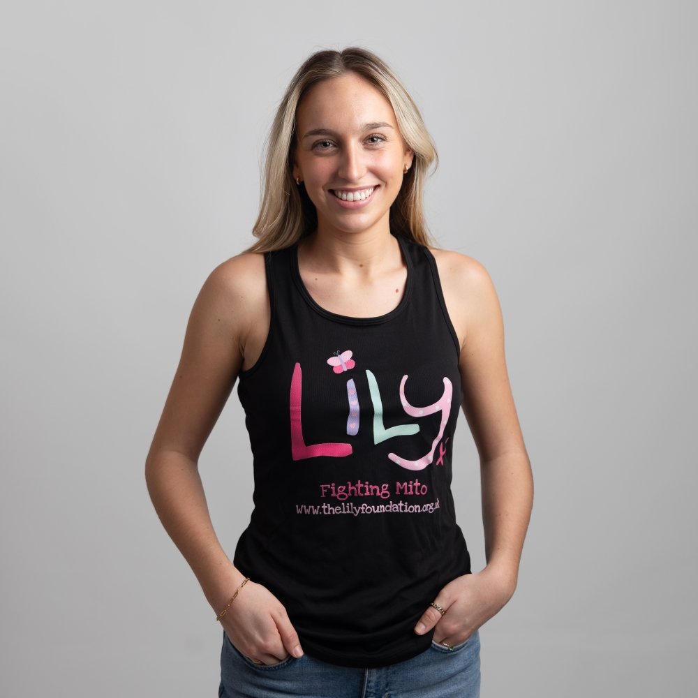 A smiling woman in a black vest featuring the Lily Foundation logo and fighting mito underneath.