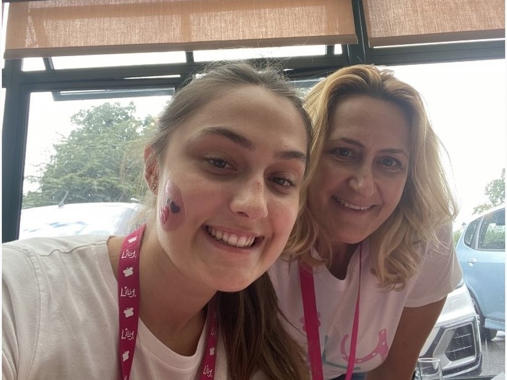 Close-up of Becca and her mum wearing face paint and smiling