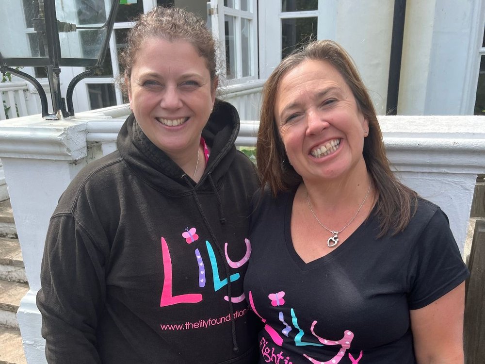 Two women in Lily branded tops smiling in preparation for their London Marathon training