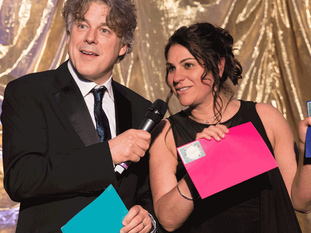 Comedian Alan Davies on stage with Lily CEO Liz