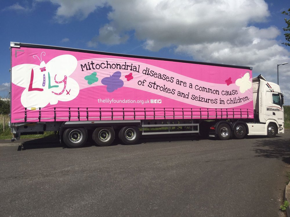 A large lorry with a Lily Foundation logo all the way down the side