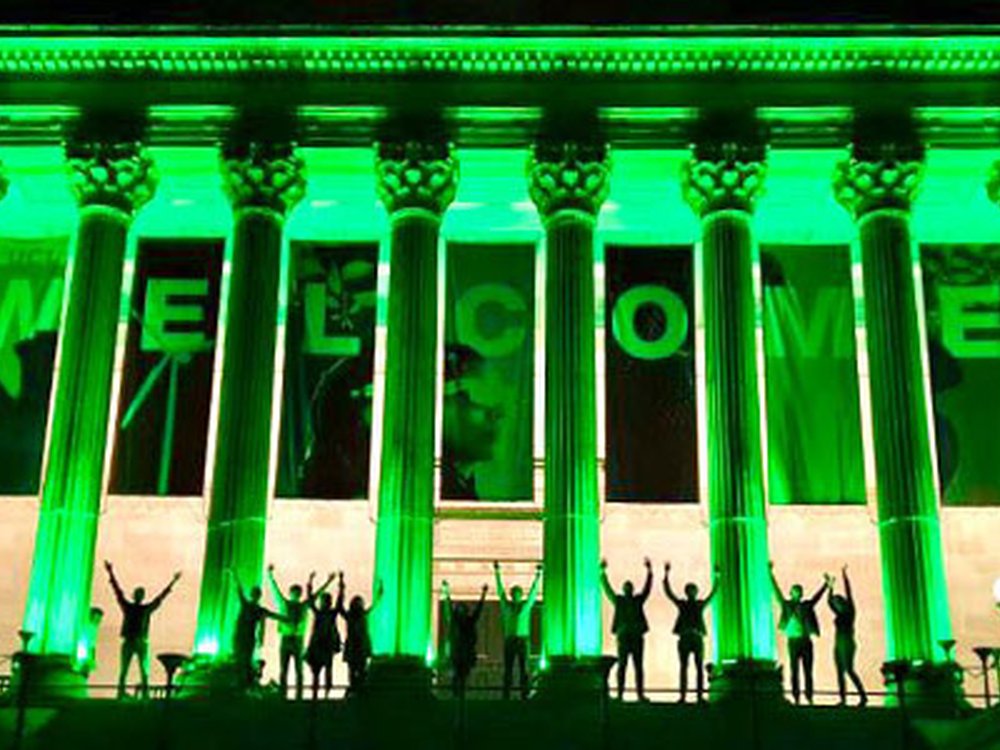 UCL Portico building front in London lit up green at night