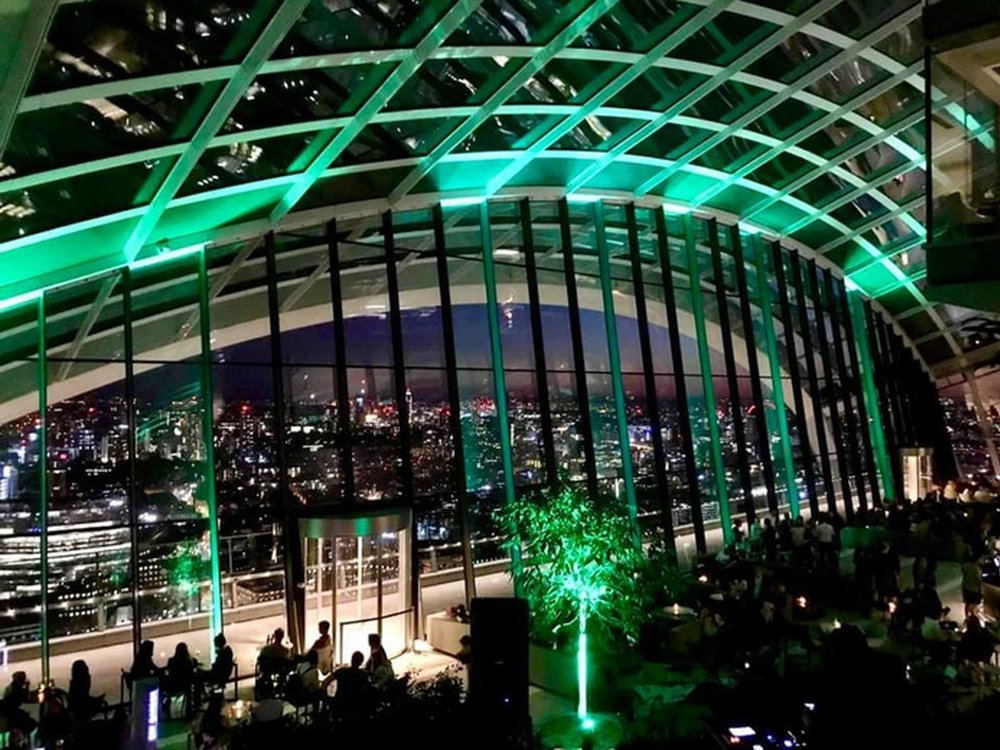The Sky Garden in London lit up green in the darkness for world mitochondrial disease week