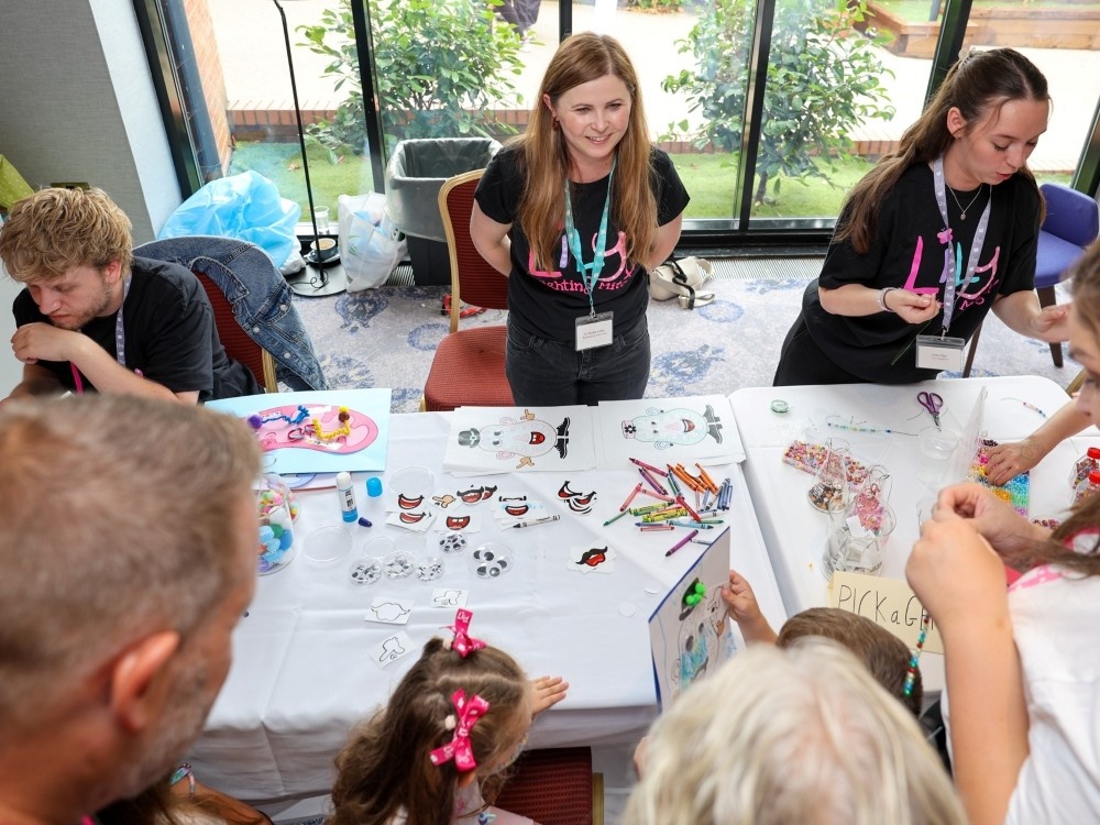 A group of researchers hosting a research-themed game at the Lily support weekend