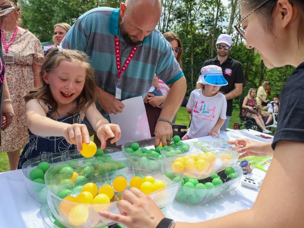 A young girl at the Lily family weekend getting stuck into a science experiment