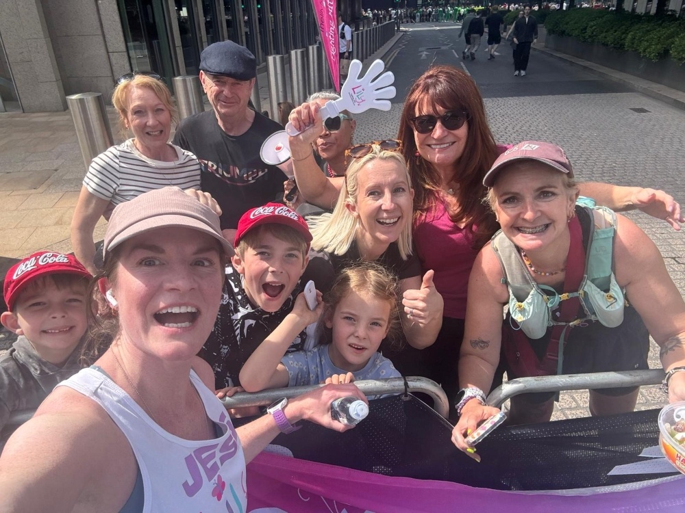 A Lily runner standing with her family smiling at the London marathon