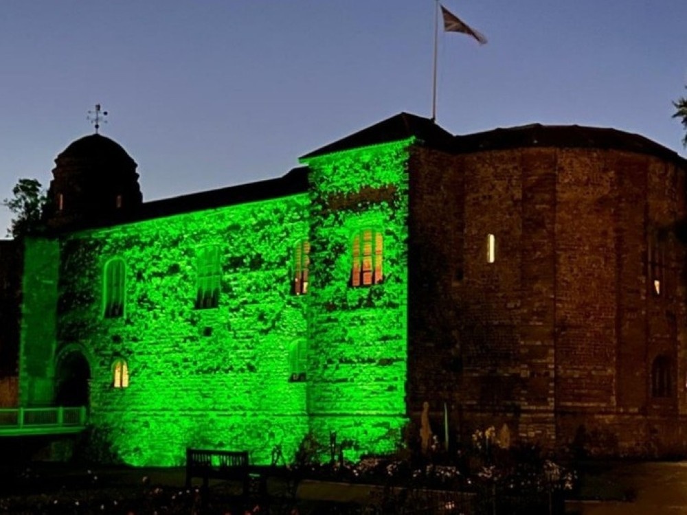 The castle in Colchester lit up green in the darkness to mark Light Up for Mito