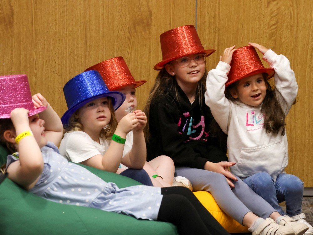 Five young girls at the Lily Family Weekend wearing magician's hats