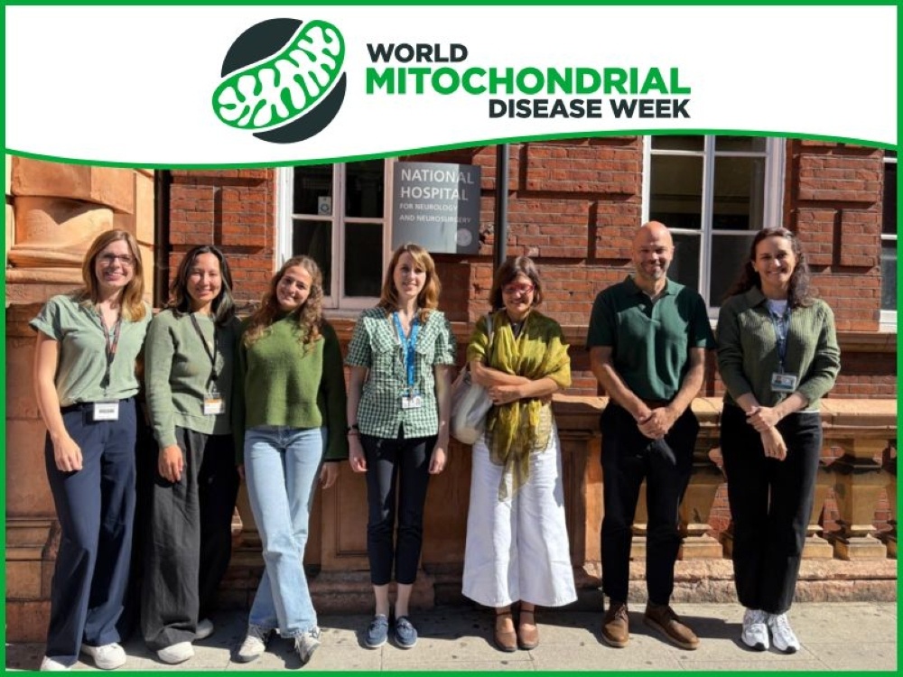 Members of the London mito team standing outside their building wearing green articles of clothing for awareness week