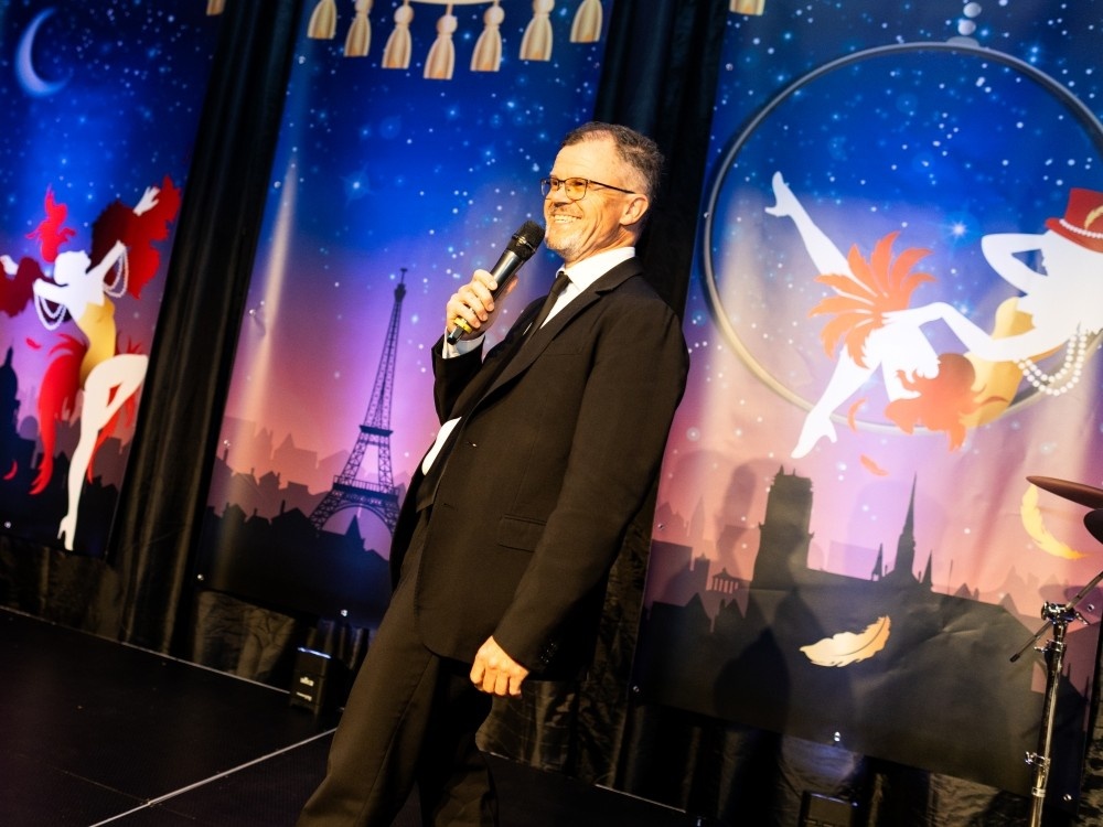 Lily Foundation ball host Dominic Holland on stage at the Burlesque ball