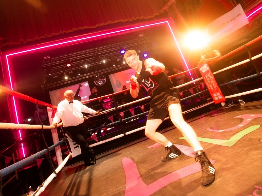 A Lily Foundation boxer gees up the crowd in the Clapham Grand