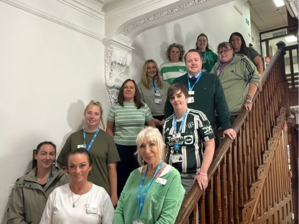 Members of the Beaumont Hospital standing on a staircase wearing green for awareness week
