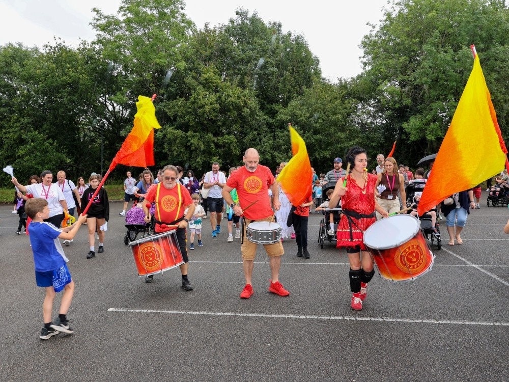 A group of drummers performing outdoors at the Lily Foundation family weekend