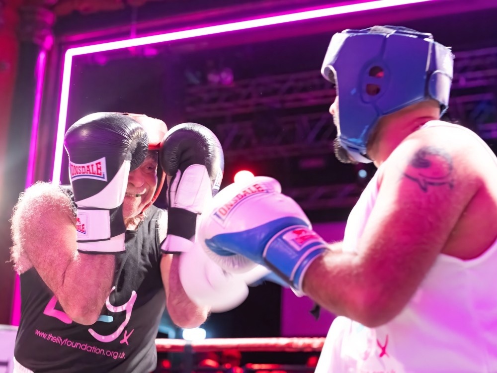 Two boxers coming together in the ring