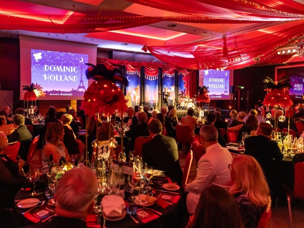 A ballroom dressed in red and black for The Lily Foundation's charity ball