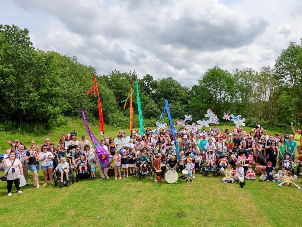 A group of people standing together in a field at the Lily support weekend