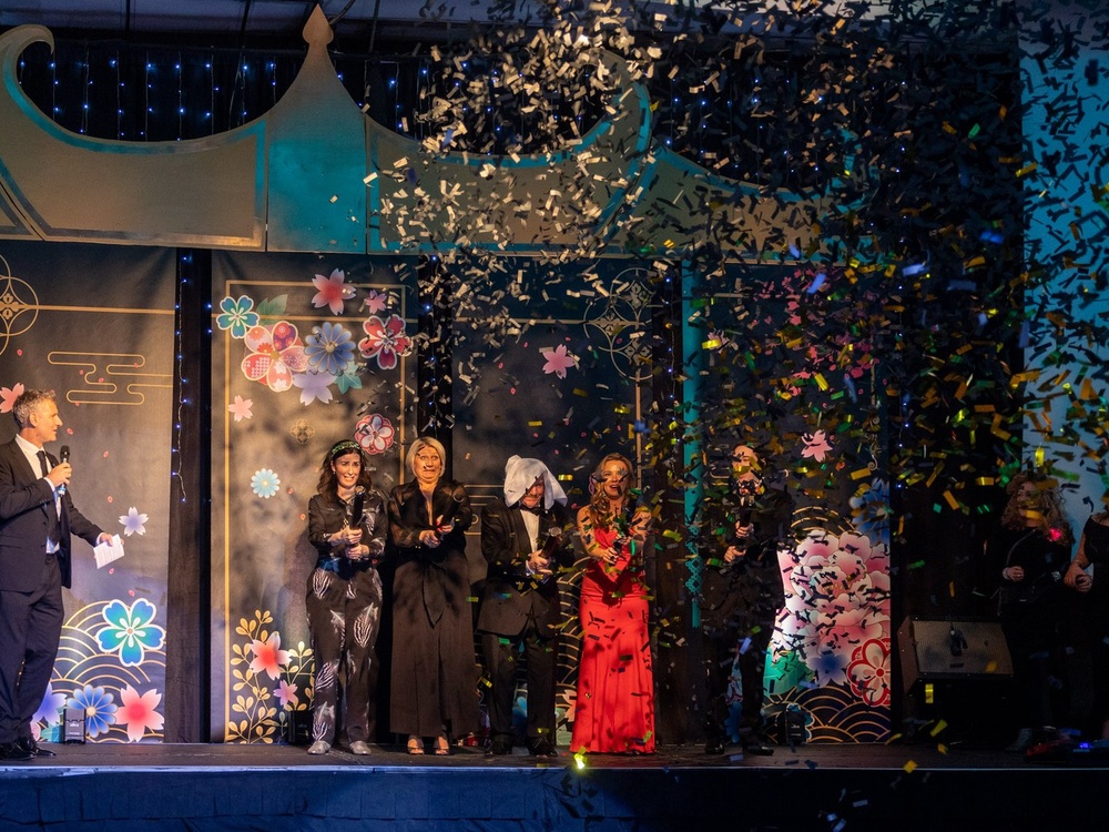 Raffle winners on stage let off confetti cannons to choose an overall winner