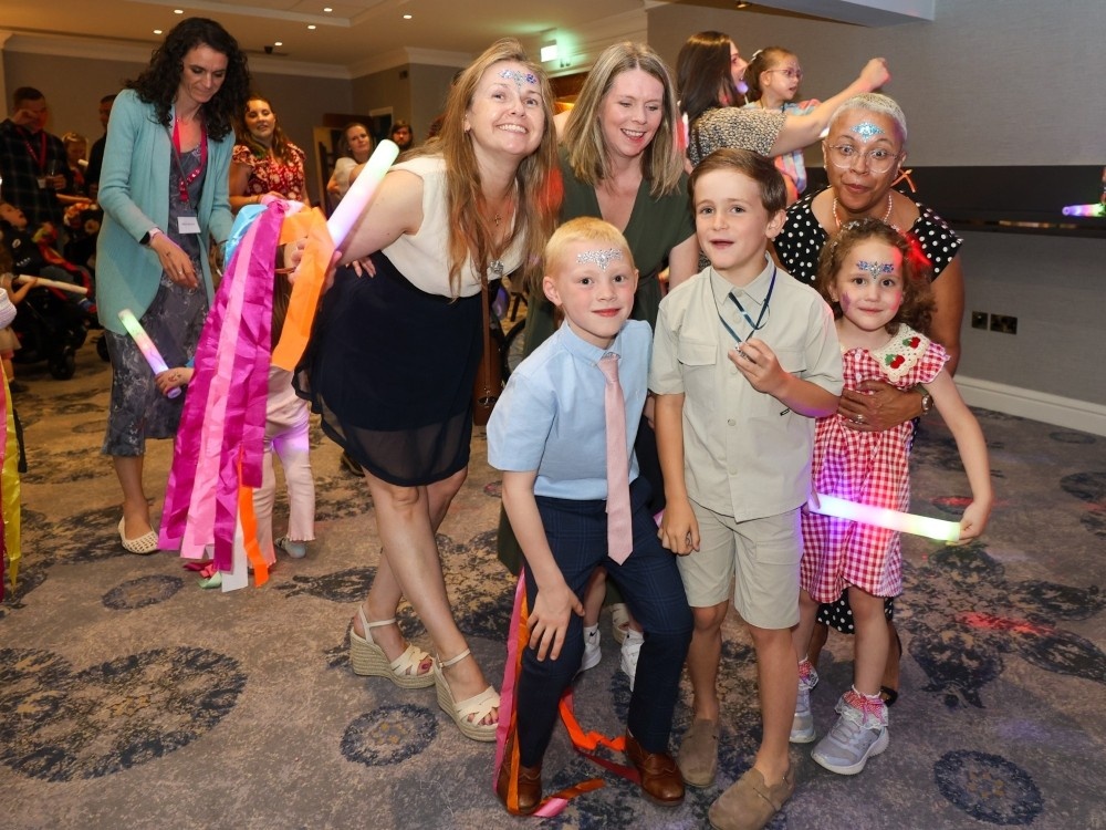 A family group standing together on the dancefloor at the Lily weekend