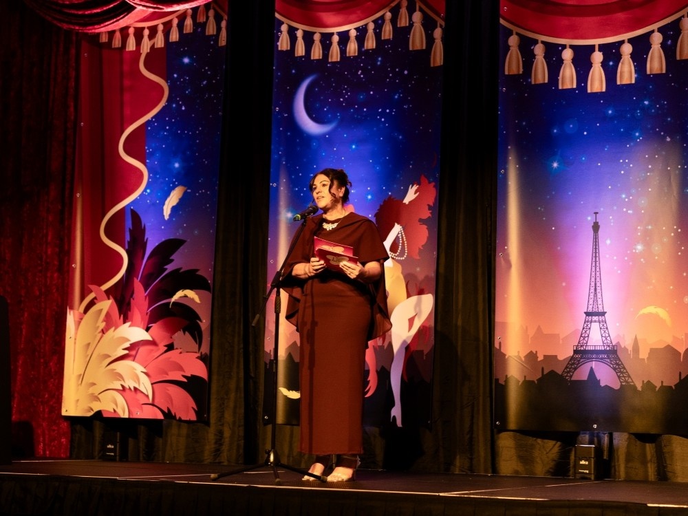 Lily Foundation CEO Liz Curtis speaking on stage at the Lily ball