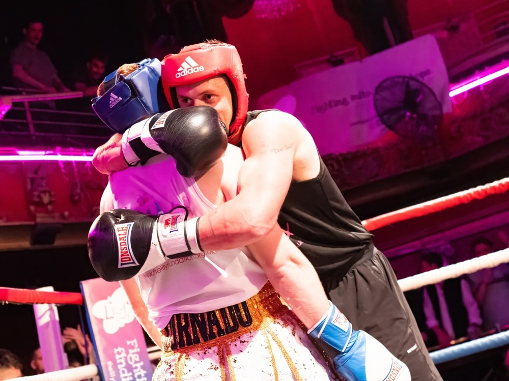 Two Lily fighters embrace in the ring at the Clapham Grand