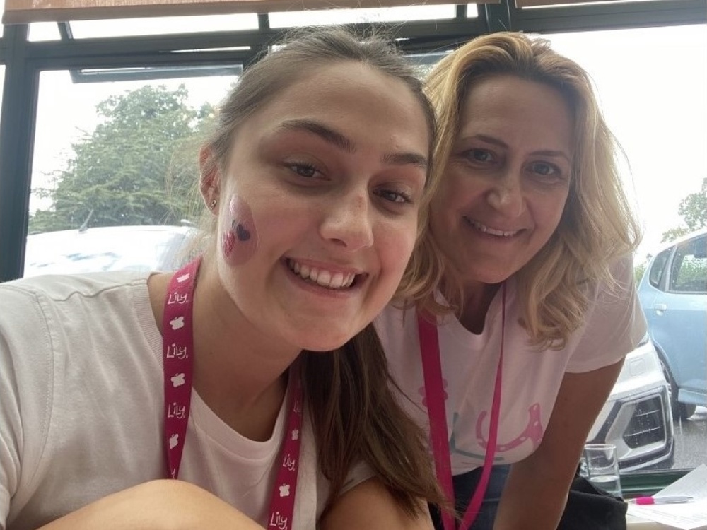 Close-up of Becca and her mum wearing face paint and smiling