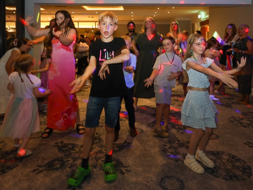 A group of adults and children on the dancefloor at the Lily weekend