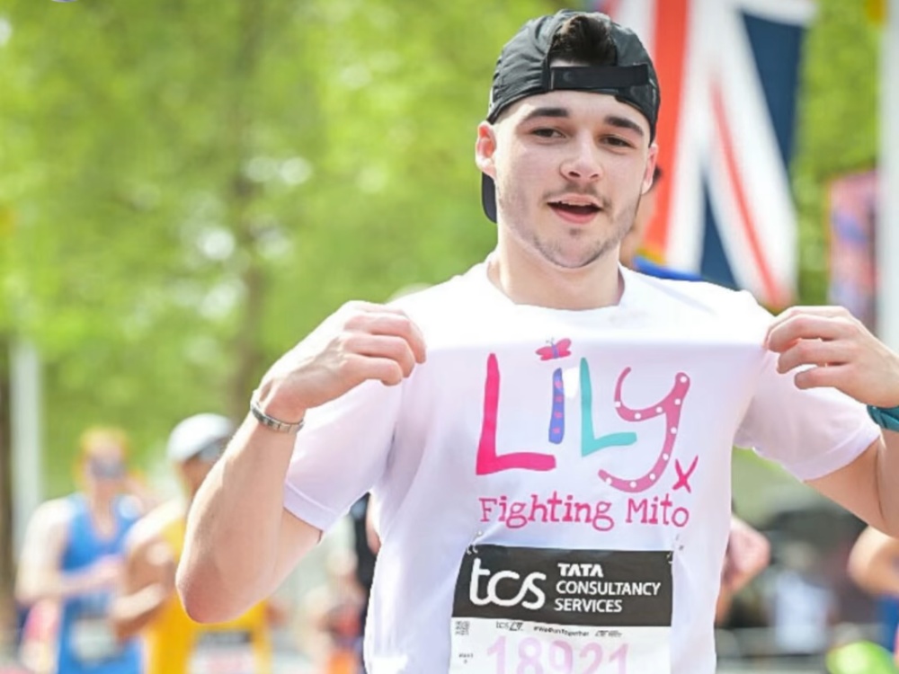 A London marathon runner holds his Lily top proudly
