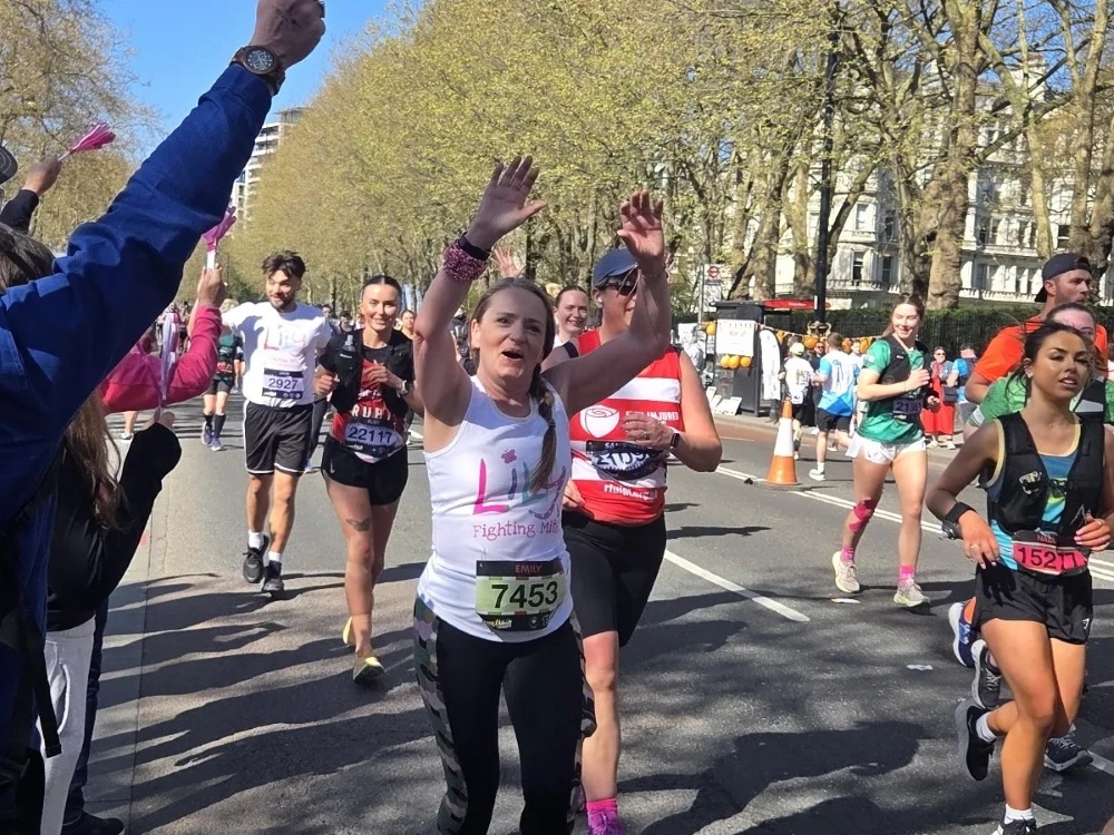 A lady in a Lily Foundation top running through London's streets