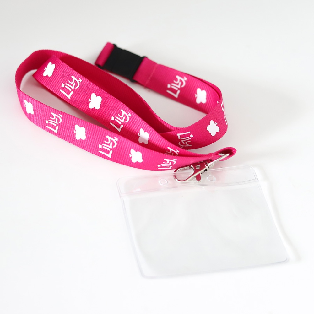 A pink lanyard featuring butterflies and the Lily Foundation logo in white, with a plastic card holder attached.