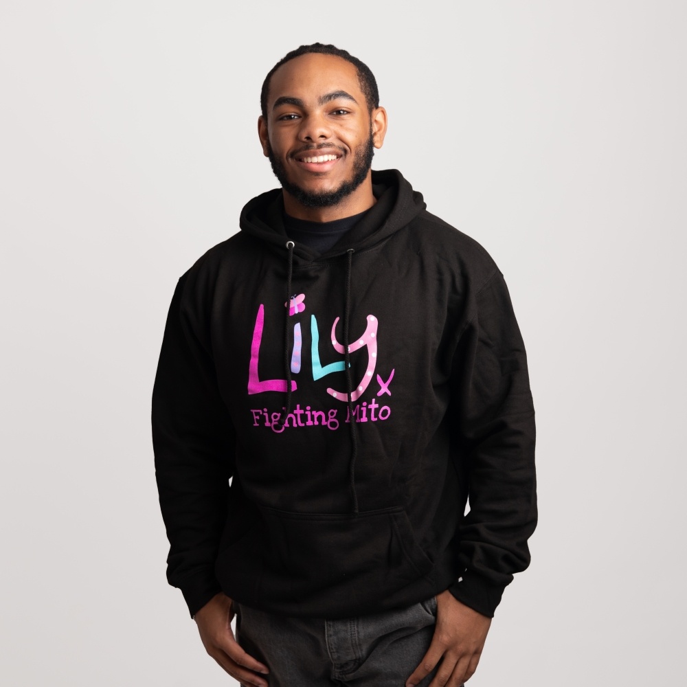 A smiling man in a black hoodie featuring the Lily Foundation logo and the text fighting mito.
