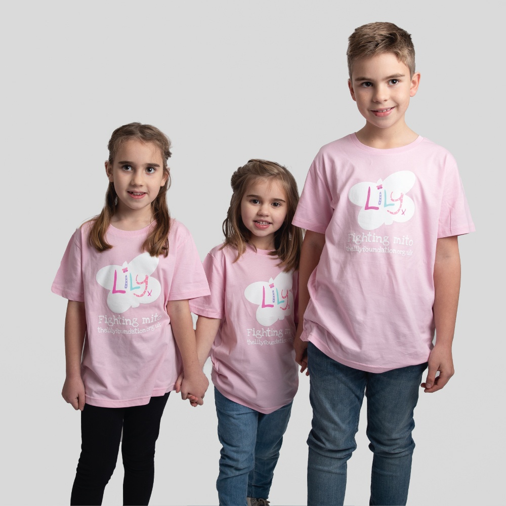 Two young girls & a boy all wearing pink t-shirts featuring the Lily Foundation butterfly logo & the text Fighting Mito.