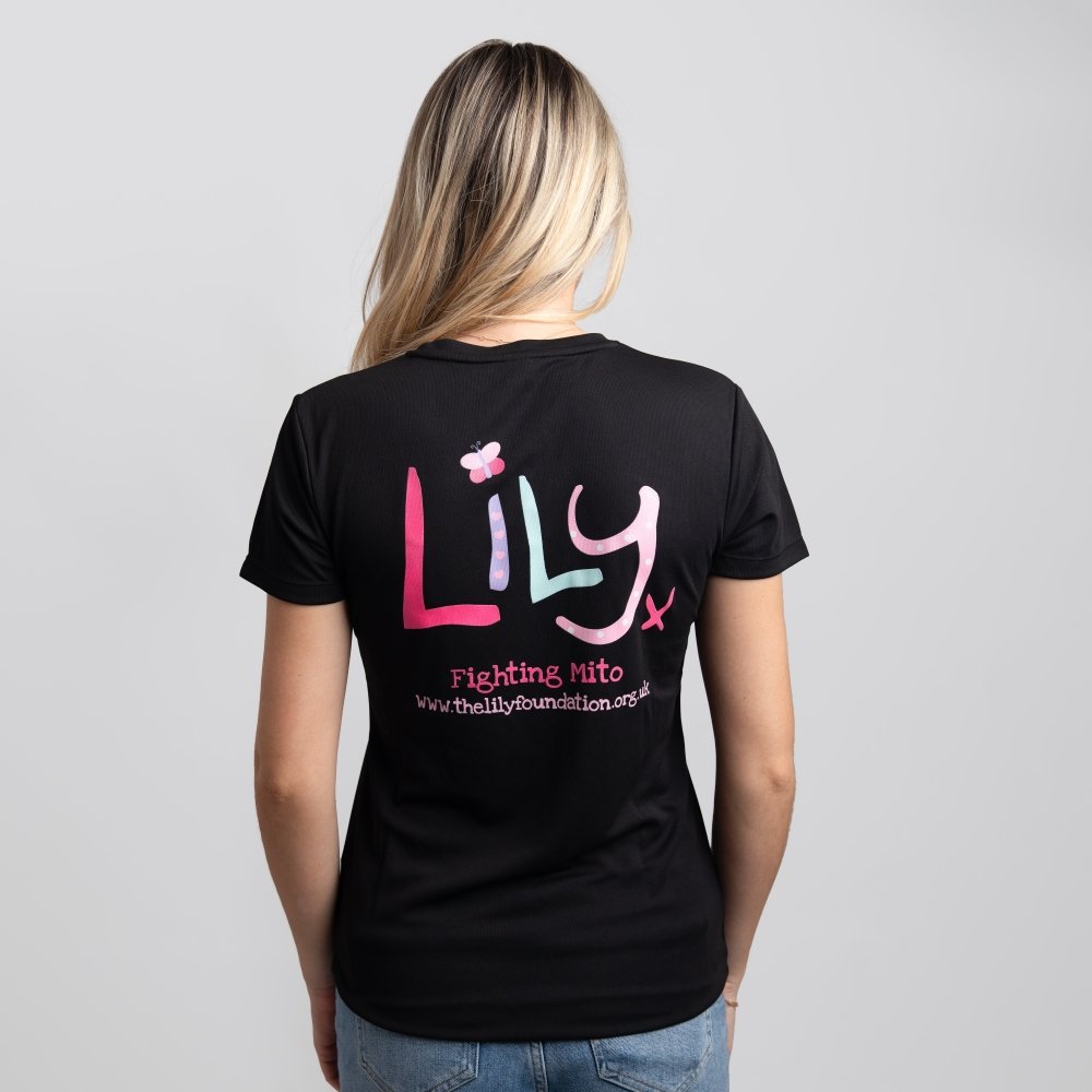 The back of a woman in a black t-shirt featuring the Lily logo and Fighting Mito underneath
