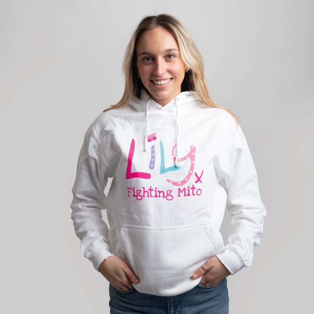 A smiling woman in a white hoodie featuring the Lily Foundation logo and the text fighting mito underneath.