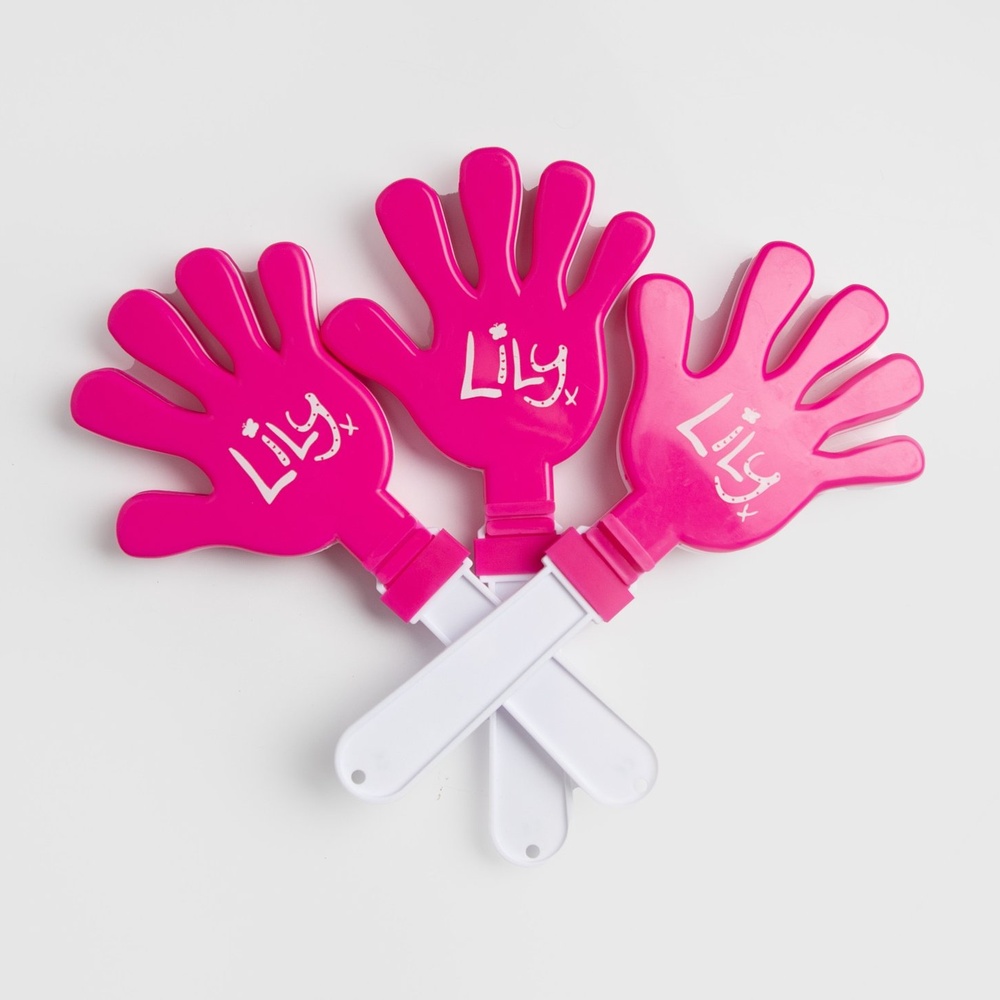 Three pink plastic hand shaped clappers featuring the Lily Foundation logo in white.