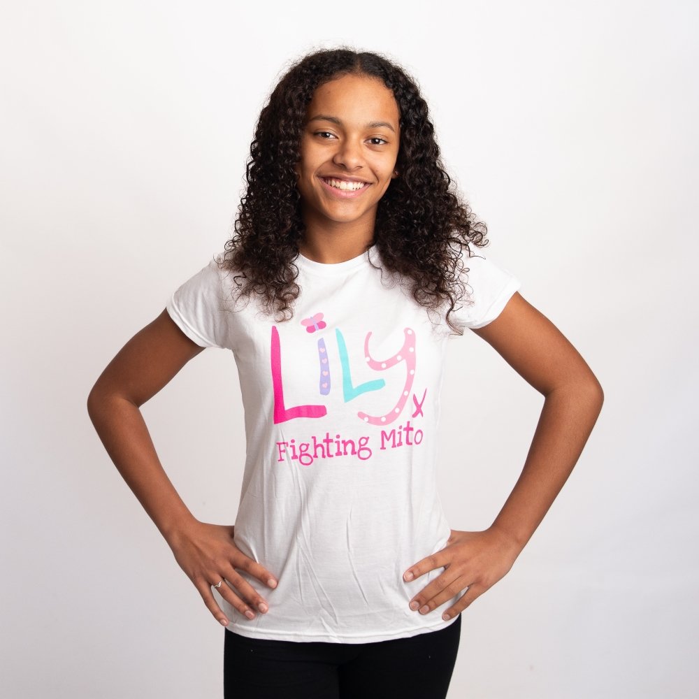 A young girl wearing a white t-shirt featuring the Lily Foundation logo and the website address.