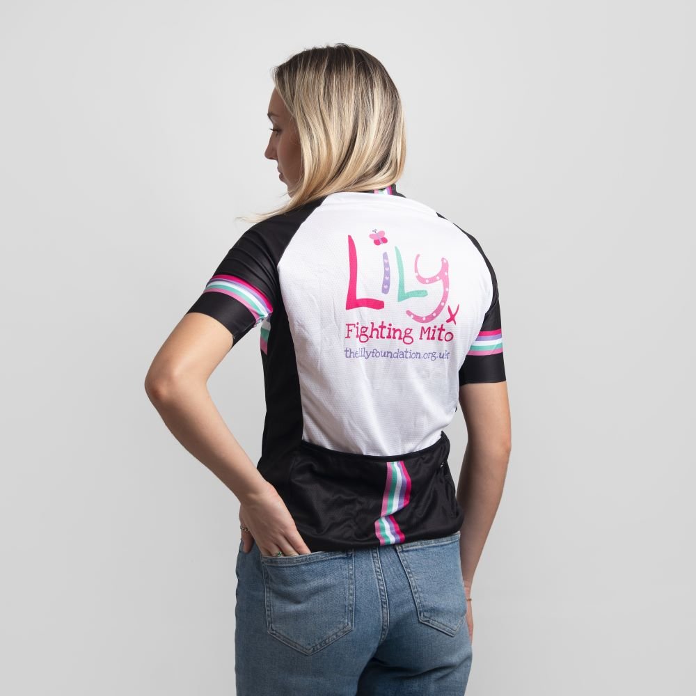 The back of a lady in a cycling top with coloured stripes and the Lily Foundation logo and website address