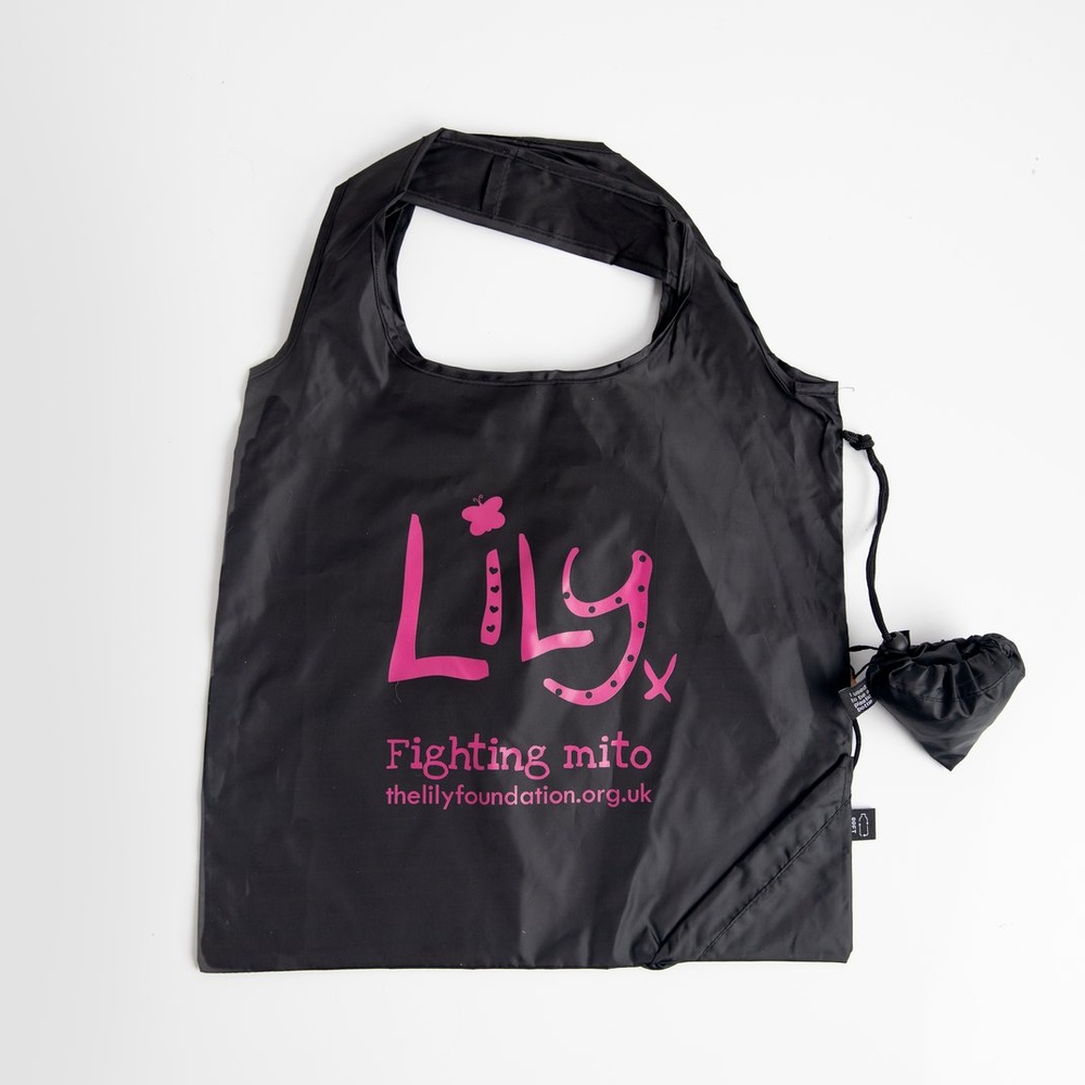 A black shopping bag featuring the Lily Foundation logo and websitre address in pink as well at the words fighting mito.