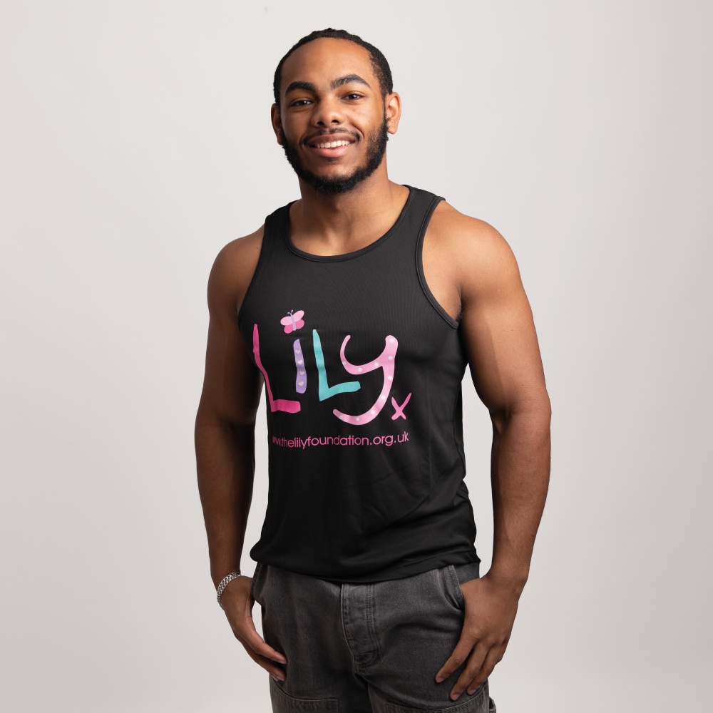 A smiling man in a black vest featuring the Lily Foundation logo and website address.