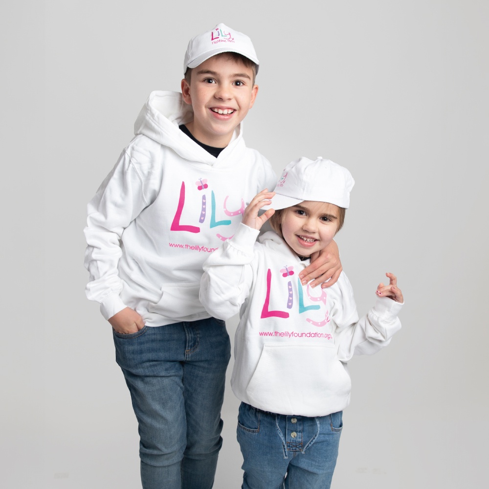 A young boy and girl both wearing white hoodies featuring the Lily Foundation logo and website address.