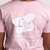 The back of a young girl wearing a pink t-shirt with the Lily Foundation butterfly logo and Fighting Mito strapline