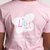The back of a young girl wearing a pink t-shirt with the Lily Foundation butterfly logo and Fighting Mito strapline