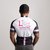 The back of a man in a cycling top with coloured stripes and the Lily Foundation logo and website address