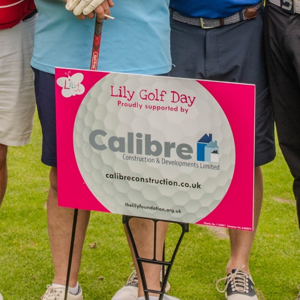 Close-up of a hole sponsorship board at the Lily golf day