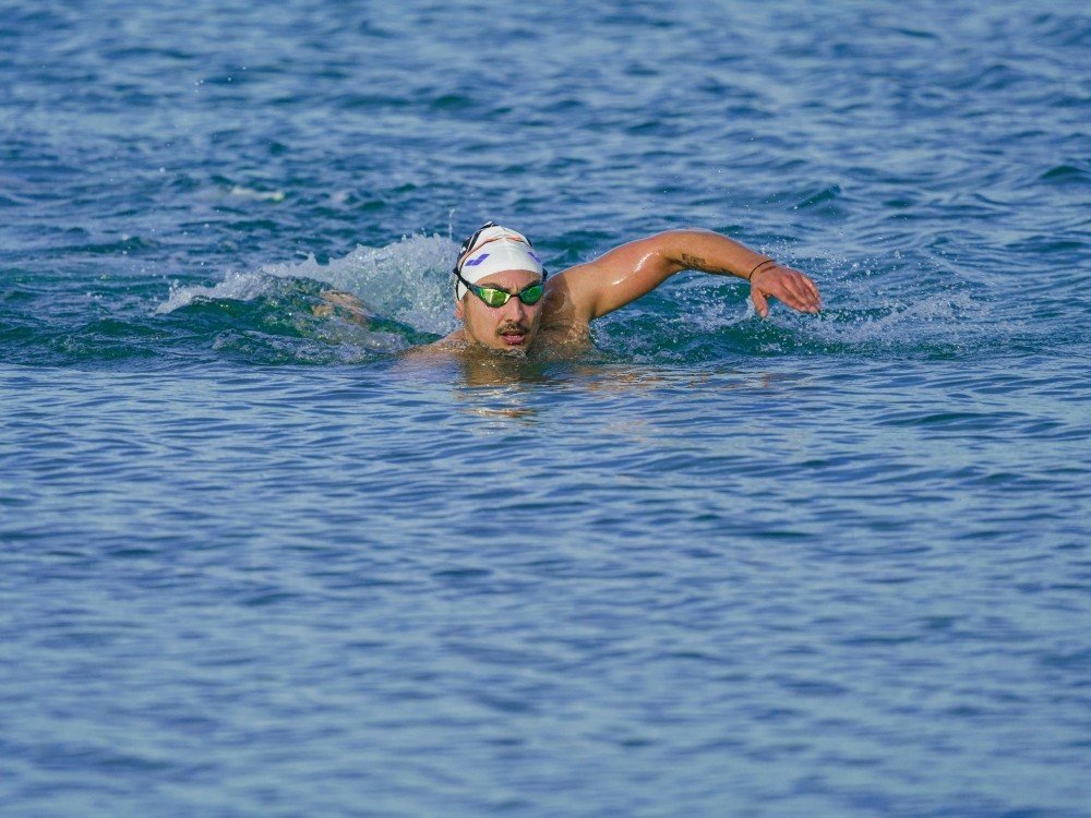 Great North Swim 2026 - A man wearing a white cap swimming front crawl in open water