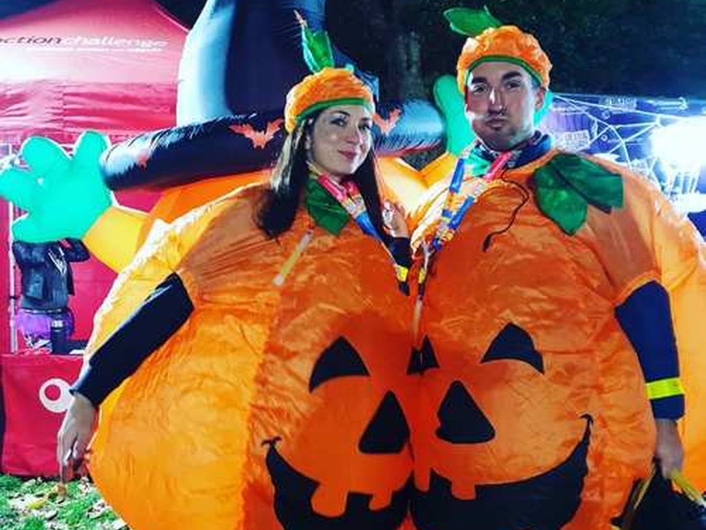 London Halloween Walk 2025 - Two fundraisers at the London Halloween Walk wearing inflatable pumpkin outfits