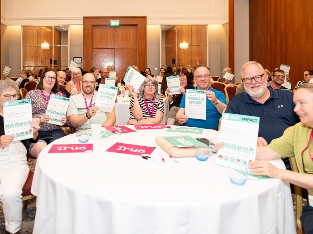 A group of adult mitochondrial disease patients sitting around a table at the Lily support weekend